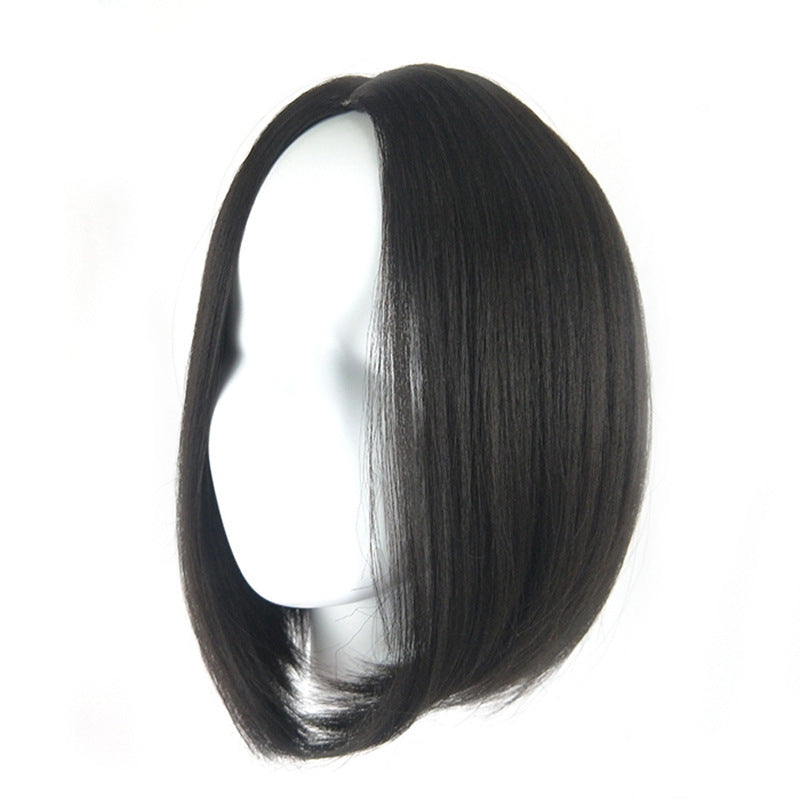 The actual black bob wig on a mannequin showing its center part and curved ends