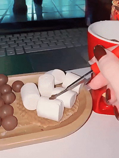 Ceramic fondue cup warming chocolate and dipping marshmallows