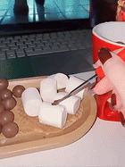 Ceramic fondue cup warming chocolate and dipping marshmallows