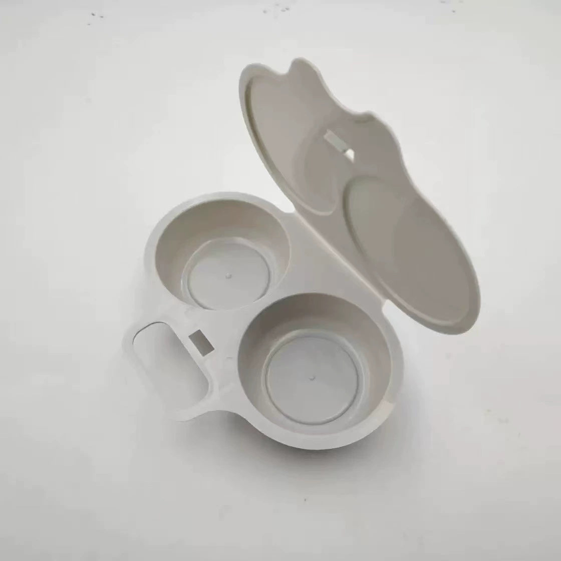 Gray maker showing hinged lid and front handle
